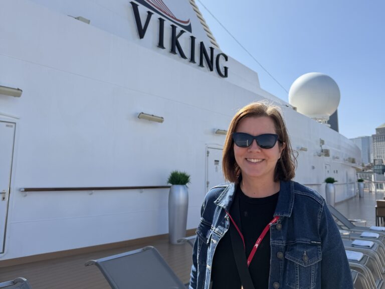 Amy Urquhart on the outdoor deck during her Viking Mars ship tour, with the Viking logo behind her.