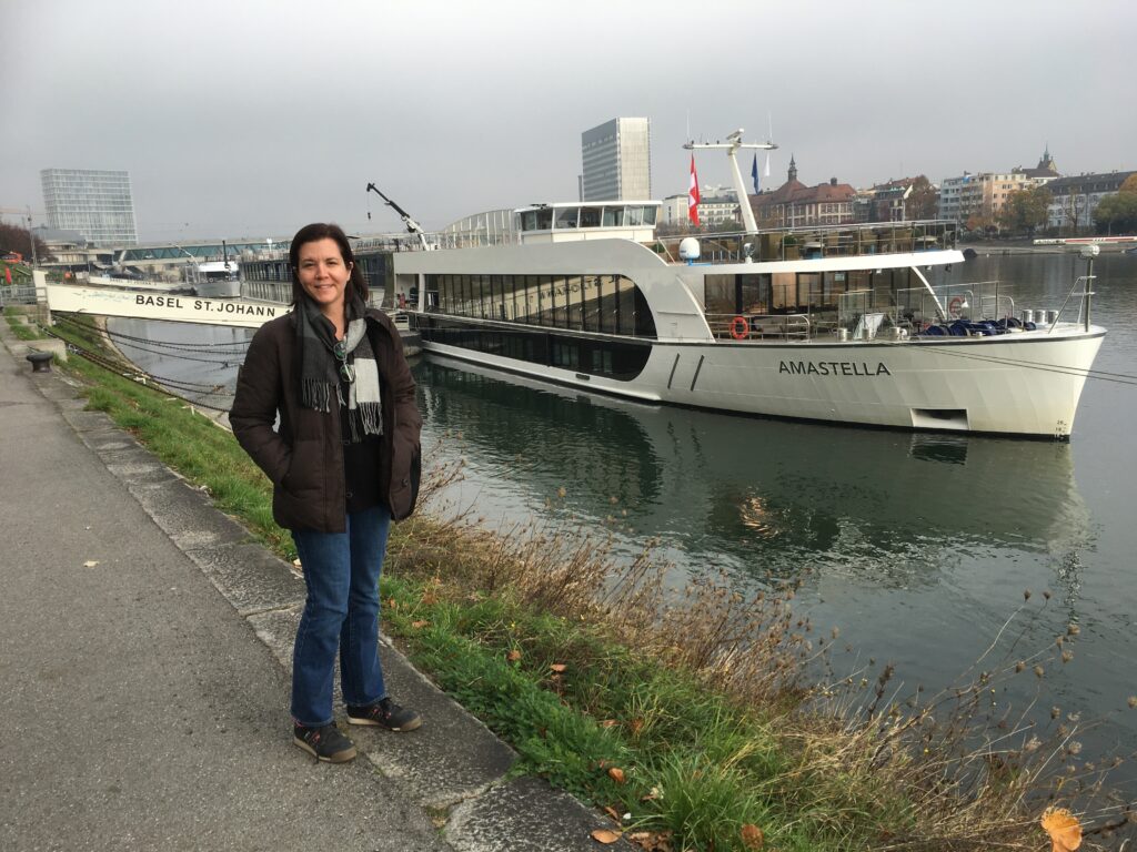 person standing in front of river cruise ship