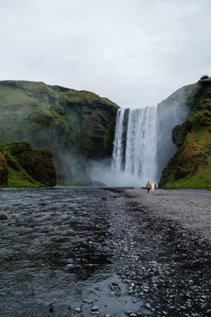 Waterfall surrounded by green cliffs in Iceland