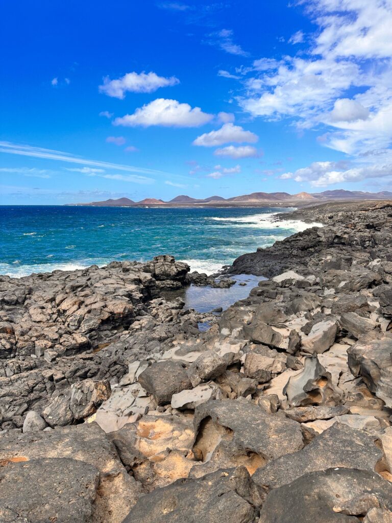 Explore the stunning rocky coastline of Lanzarote, featuring vibrant ocean views.